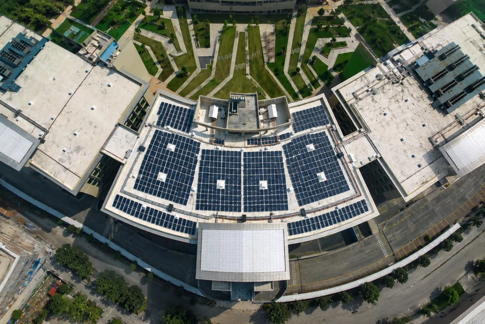 Aerial view of a large commercial rooftop solar plant by Clans Machina